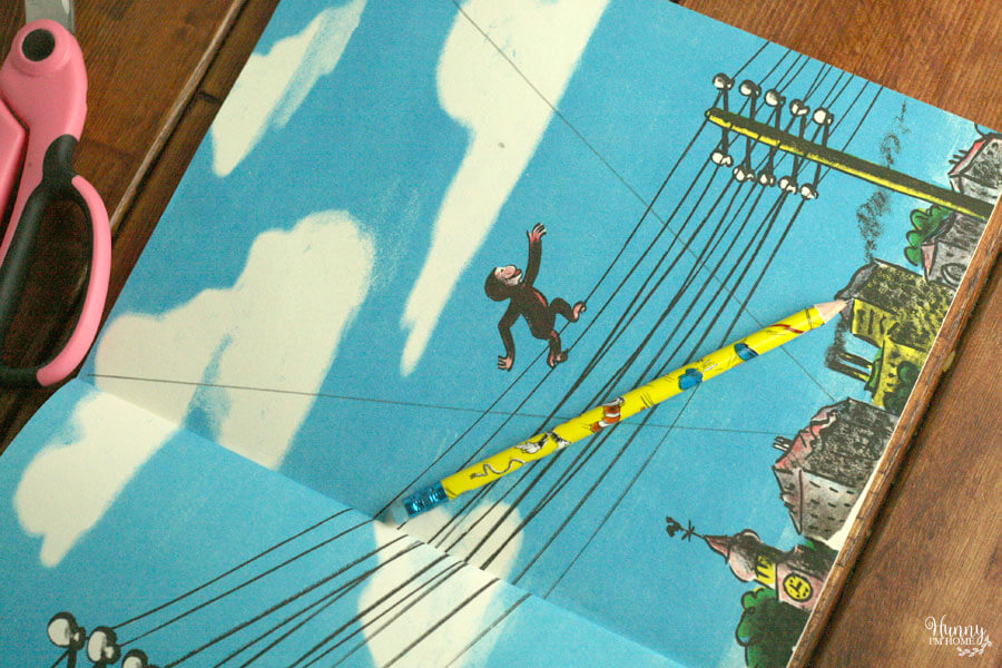Learn how to make a banner out of book pages for your next birthday party from hunnyimhomediy.com | book page banner | Curious George birthday party | Curious George party | Curious George party decorations | Curious George party ideas | Curious George decor | book page decor | book page decorations | book page crafts | book page craft ideas
