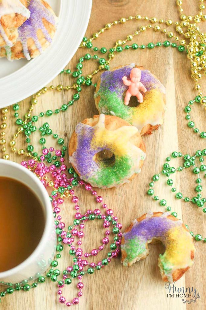 You'll love this easy gluten free king cake recipe! This turns a king cake recipe traditional into adorable gluten free king cake bundt cakes and makes king cake gluten free. These gluten free mini king cakes are the perfect way to celebrate Mardis Gras! #mardigras #glutenfree