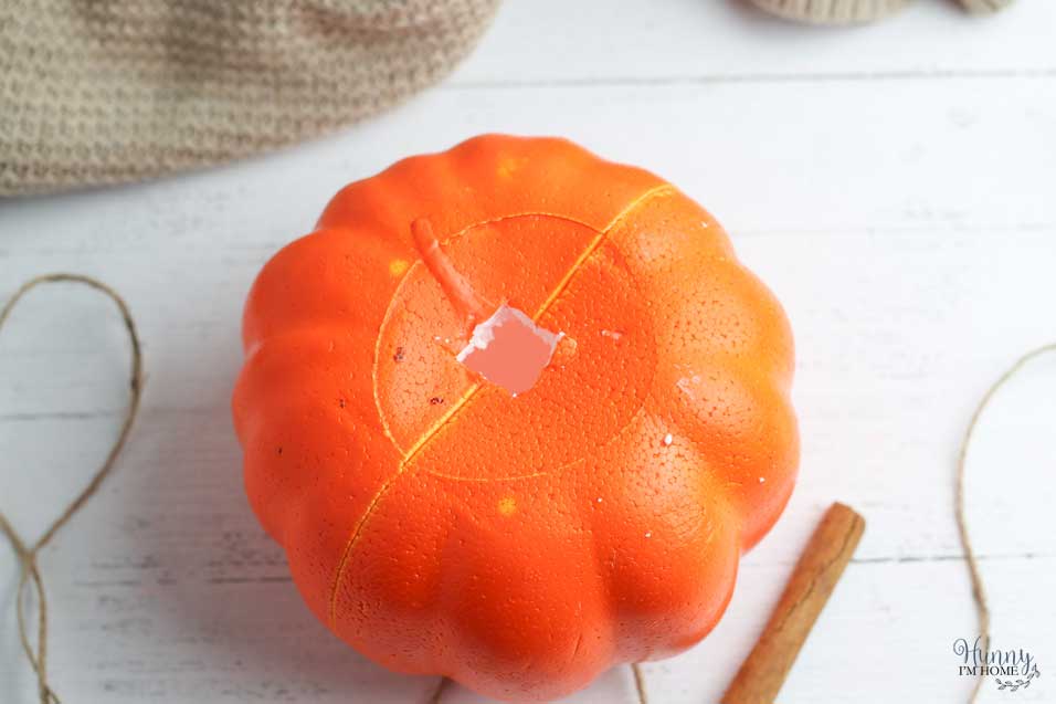 Cut a hole in the top of the Dollar Tree pumpkins