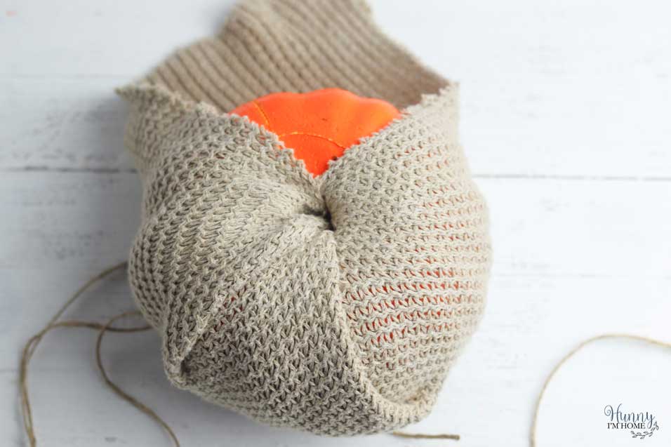 Continue wrapping the pumpkin with the sweater