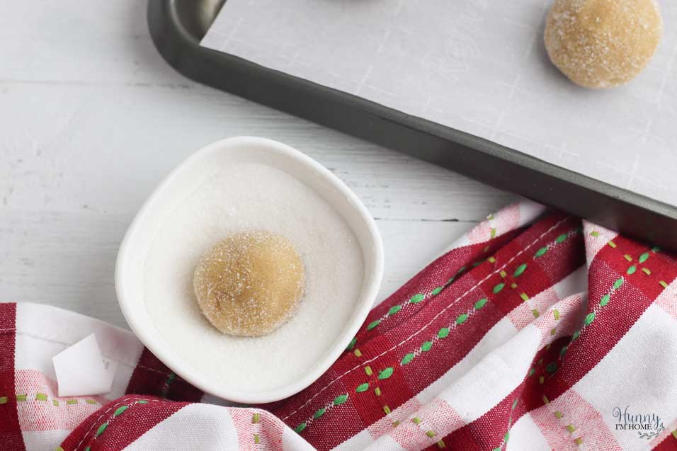 Roll the dough balls in sugar