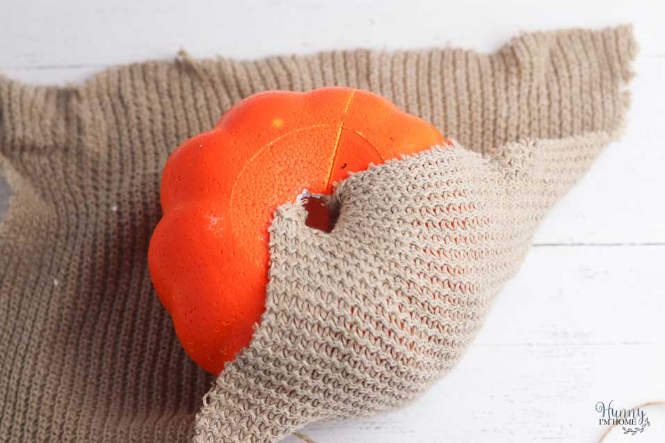 Tuck a corner of the sweater into the hole