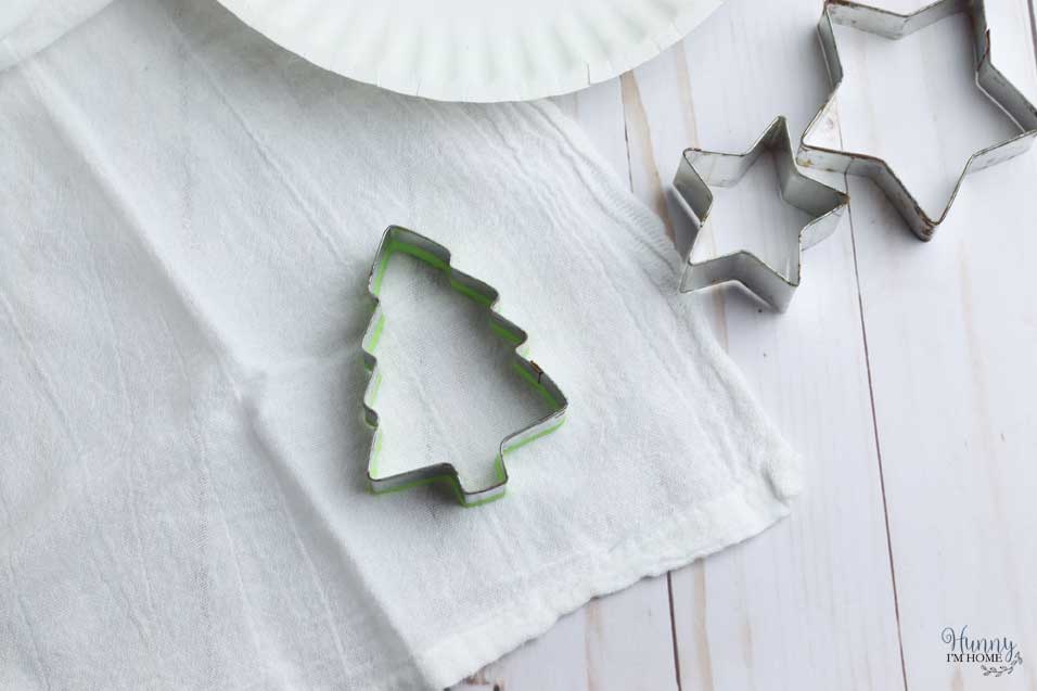 Press the cookie cutter into the Christmas tea towel