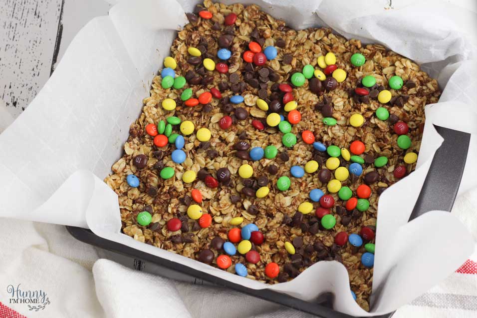 Top peanut butter granola bars with candy and chocolate chips