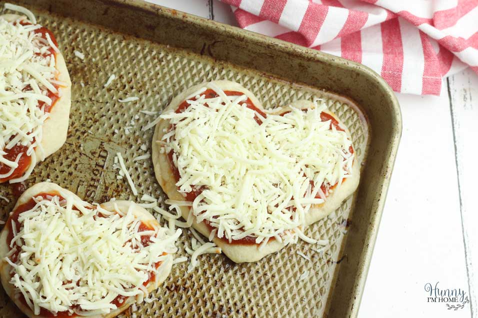 Top heart shaped pizza with cheese