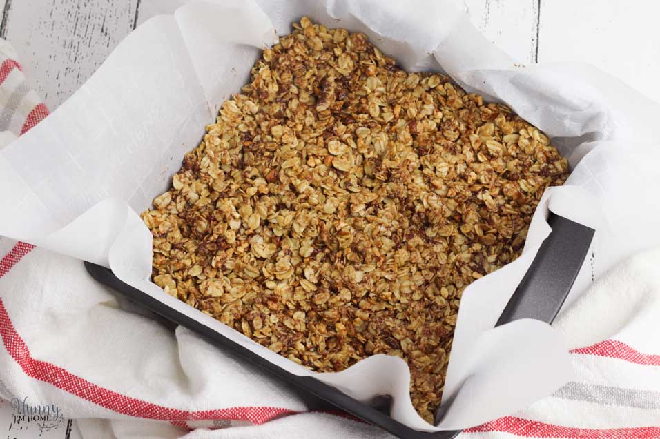 Spread gluten free granola bars into pan
