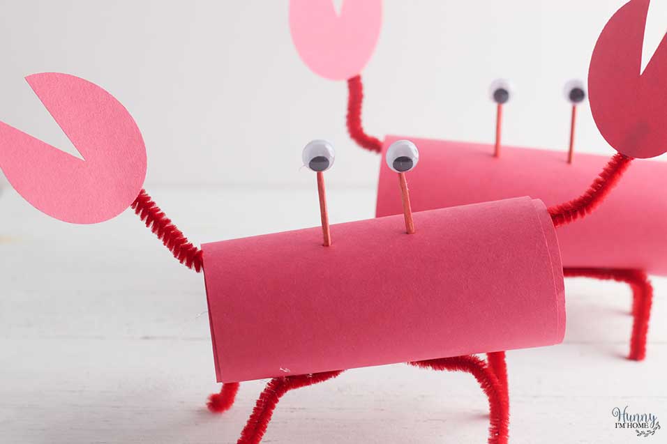 Attach the eyes to the toilet paper roll craft