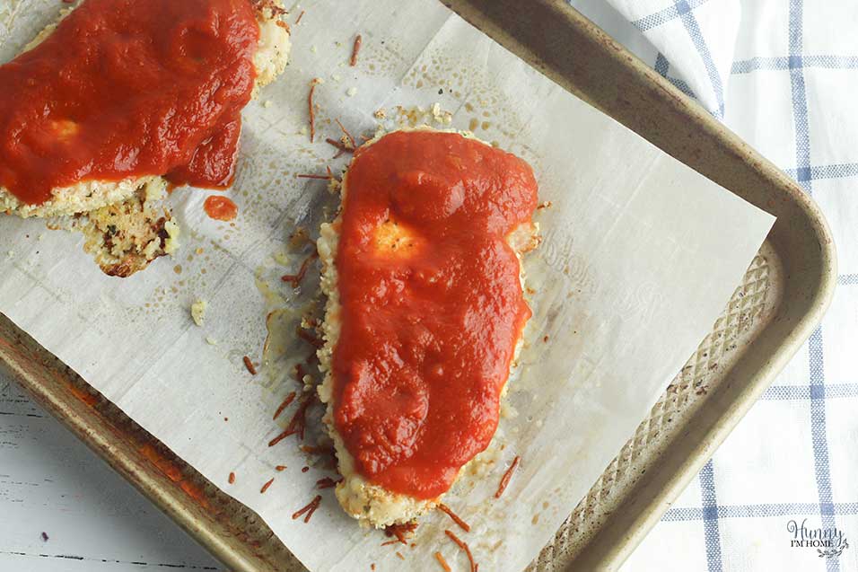 Add marinara sauce to gluten free parmesan chicken baked