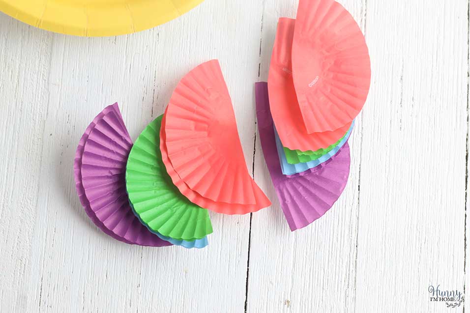 Cut cupcake wrapper fins for beach craft for kids