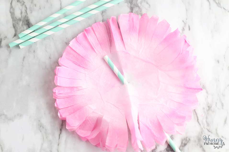 Put straw through the hole in the center of the coffee filters