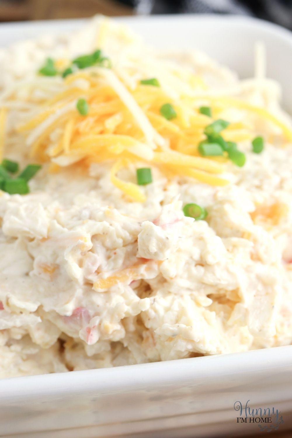 cold crab dip topped with shredded cheese and chives